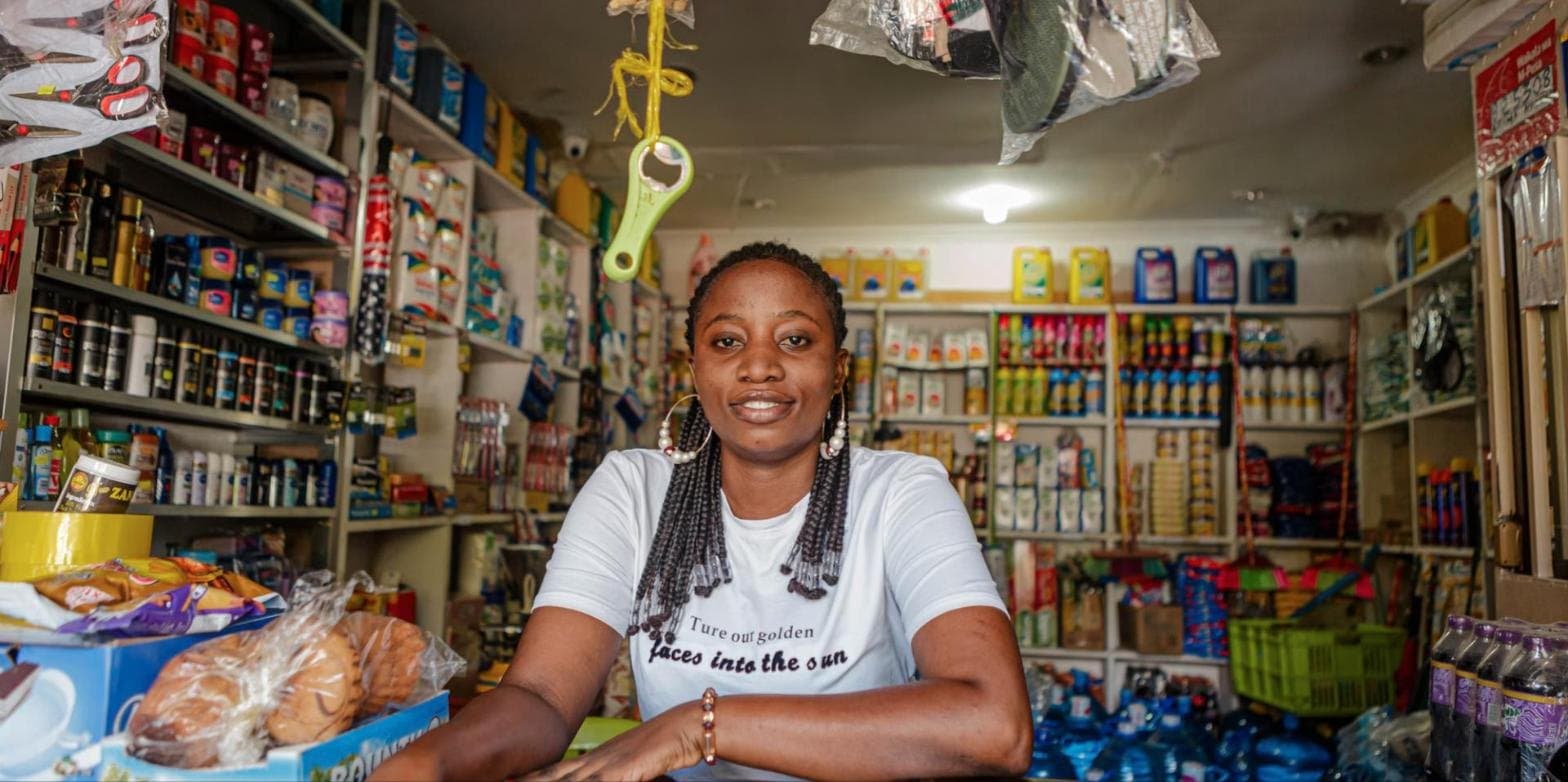 Shop owner smiling behind her counter